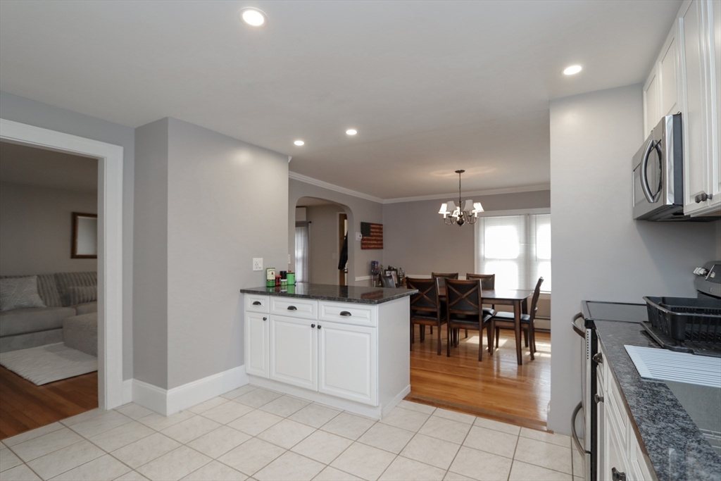 31 Thornton Street Springfield, MA 01104 - Photo 13 of 32 a kitchen with stainless steel appliances kitchen island granite countertop a sink and cabinets