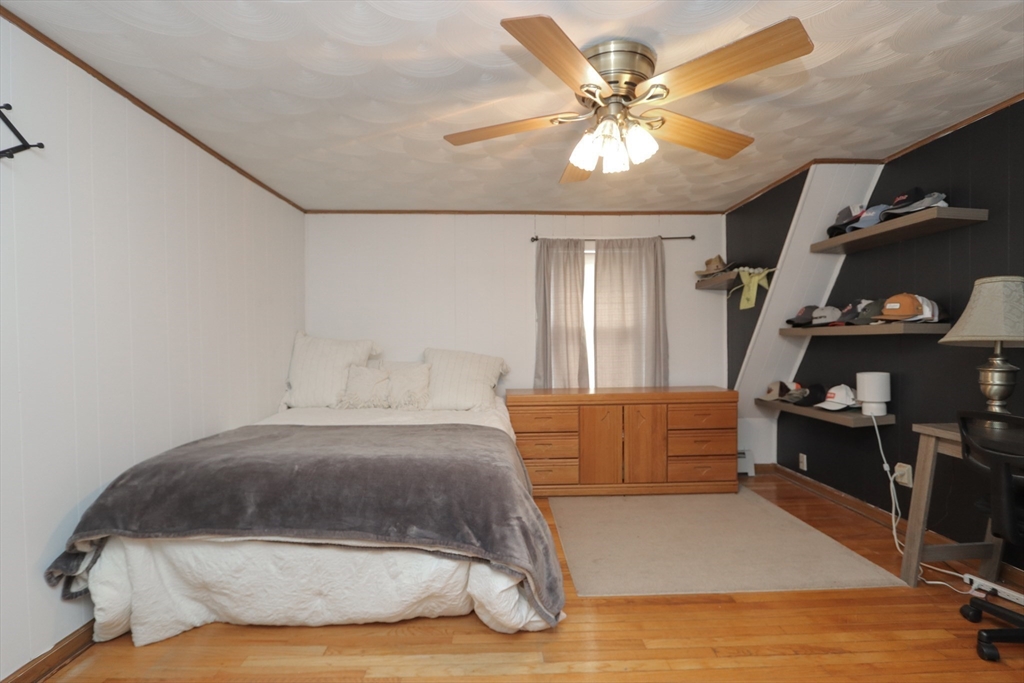 31 Thornton Street Springfield, MA 01104 - Photo 23 of 32 a bedroom with a bed and cabinets