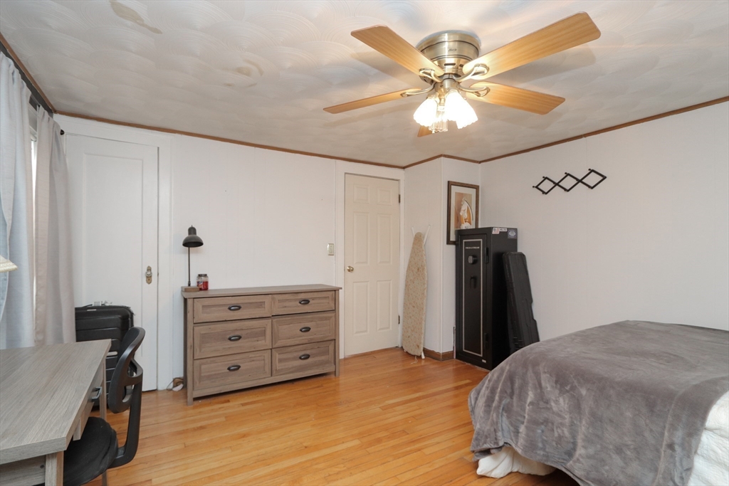 31 Thornton Street Springfield, MA 01104 - Photo 24 of 32 a bedroom with a bed and a chandelier