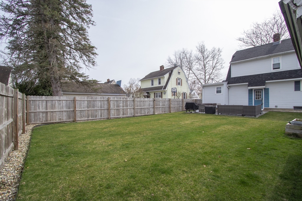 31 Thornton Street Springfield, MA 01104 - Photo 29 of 32 a view of a backyard with a garden and deck