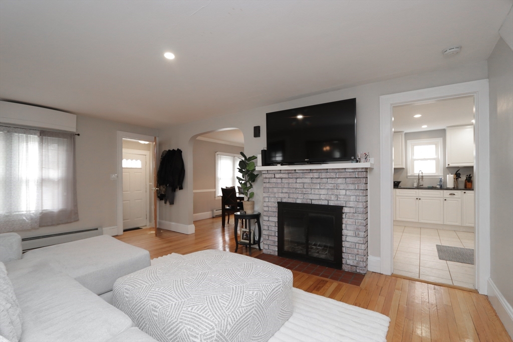 31 Thornton Street Springfield, MA 01104 - Photo 3 of 32 a living room with furniture a fireplace and a flat screen tv