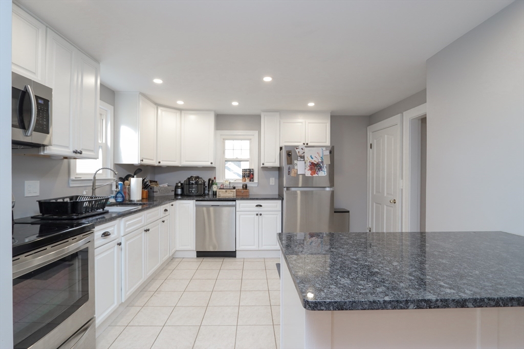 31 Thornton Street Springfield, MA 01104 - Photo 10 of 32 a kitchen with stainless steel appliances granite countertop a sink and cabinets