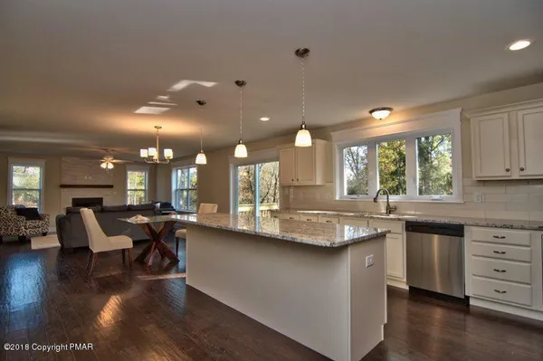 a kitchen with lots of counter top space and dining table