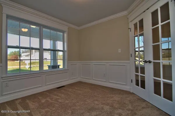 a view of a hallway with wooden floor and entryway