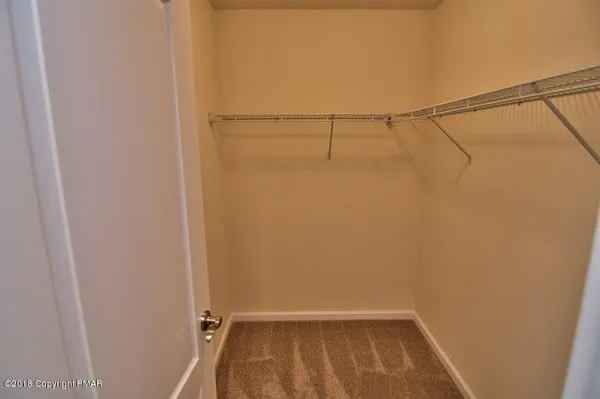 a bathroom with a granite countertop sink a large mirror and a shower