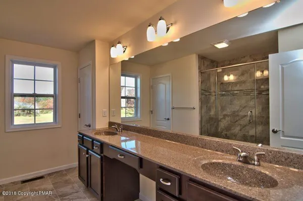 a close view of sink with granite countertop