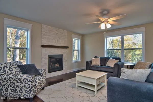 a living room with furniture and a fireplace