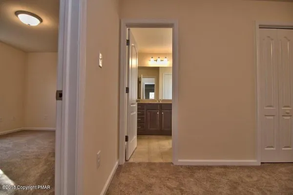 a bathroom with a sink a large mirror and cabinets