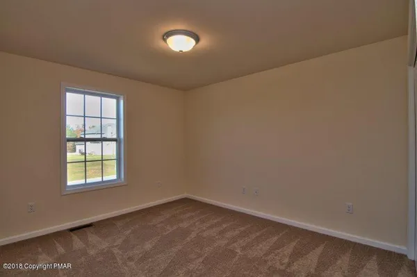 a view of an empty room with windows