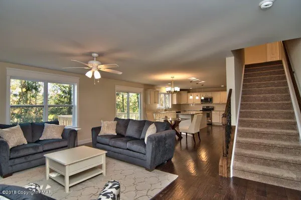 a living room with furniture and a chandelier