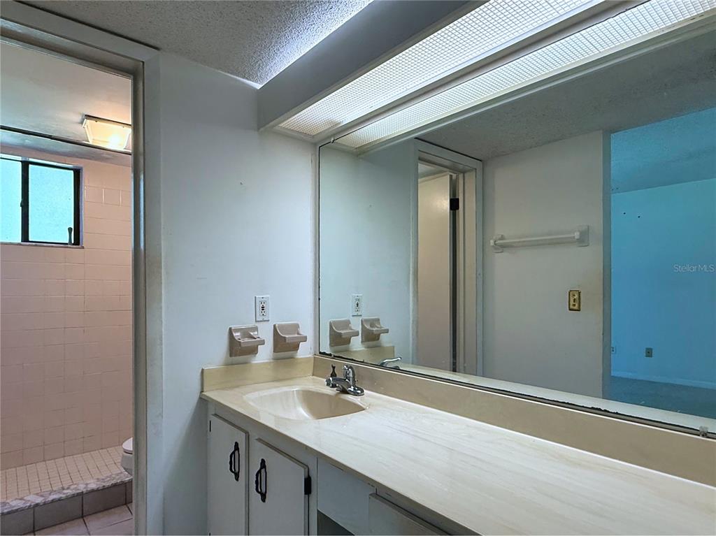 7 Surrey Court Palm Coast, FL 32137 - Photo 31 of 44 a bathroom with a granite countertop sink and a mirror