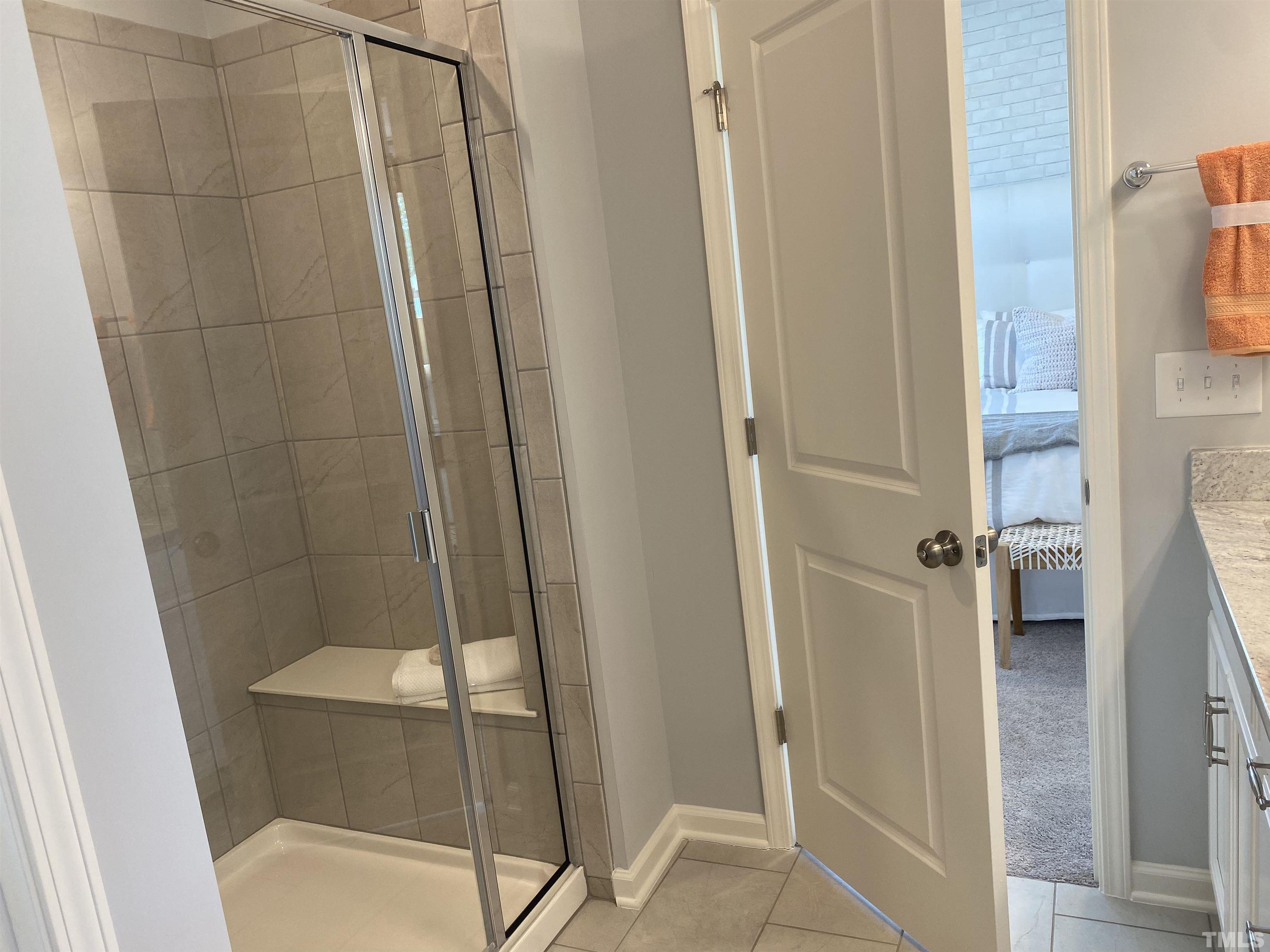 1258 Commack Drive Durham, NC 27703 - Photo 16 of 68 a bathroom with a glass shower door