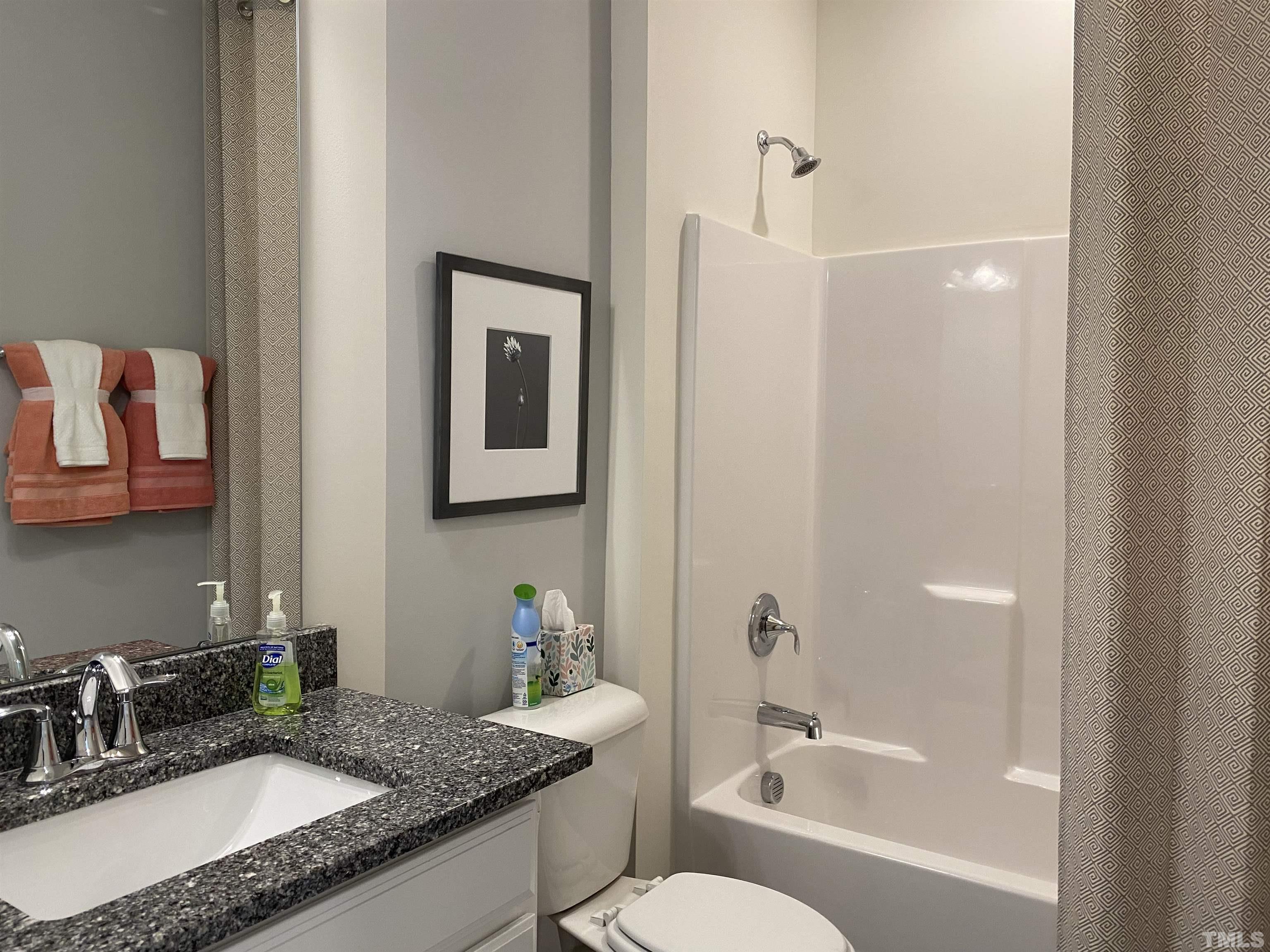 1258 Commack Drive Durham, NC 27703 - Photo 26 of 68 a bathroom with a granite countertop sink a toilet a mirror and shower