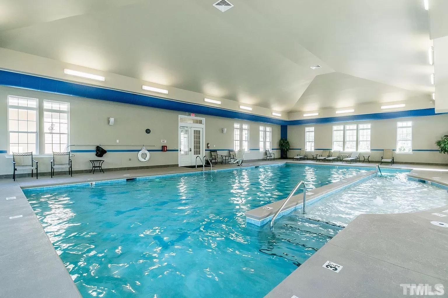 1258 Commack Drive Durham, NC 27703 - Photo 32 of 68 a view of a living room and kitchen floor to ceiling window and wooden floor