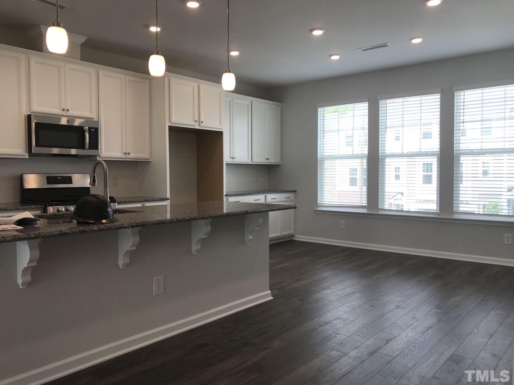 1258 Commack Drive Durham, NC 27703 - Photo 47 of 68 an open kitchen with wooden floor and large window
