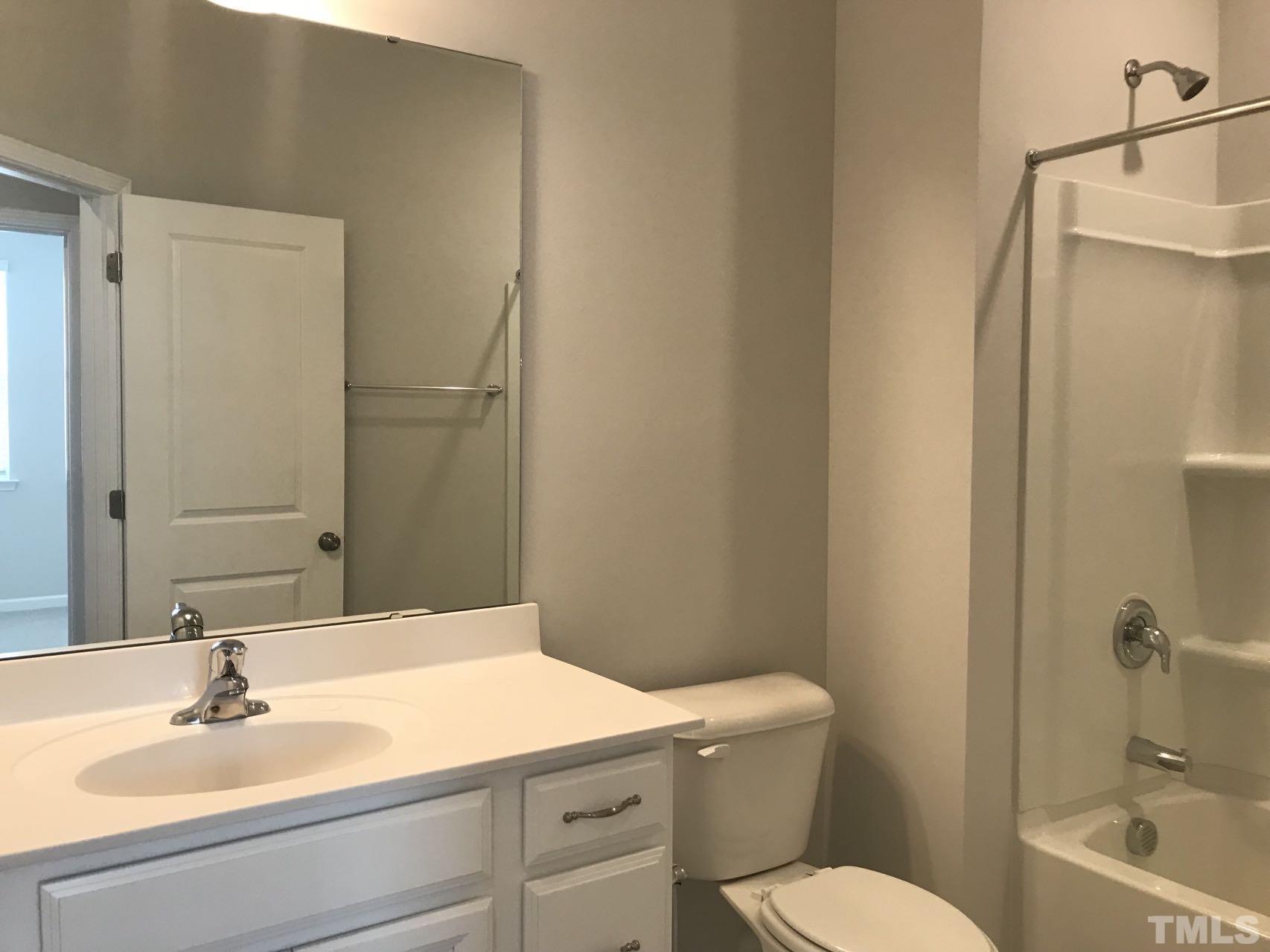 1258 Commack Drive Durham, NC 27703 - Photo 60 of 68 a bathroom with a sink a toilet and shower