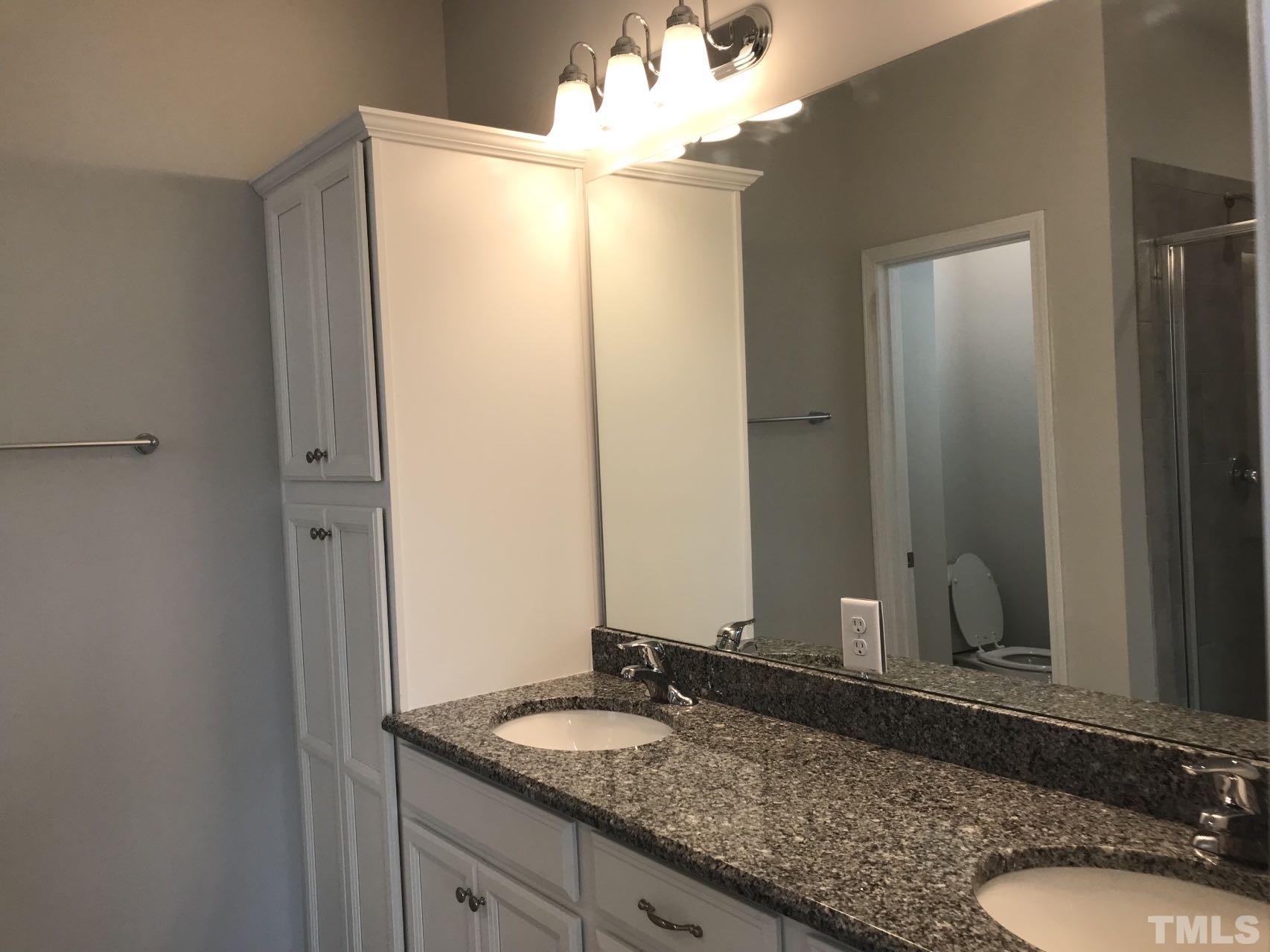 1258 Commack Drive Durham, NC 27703 - Photo 63 of 68 a bathroom with a granite countertop sink and a mirror