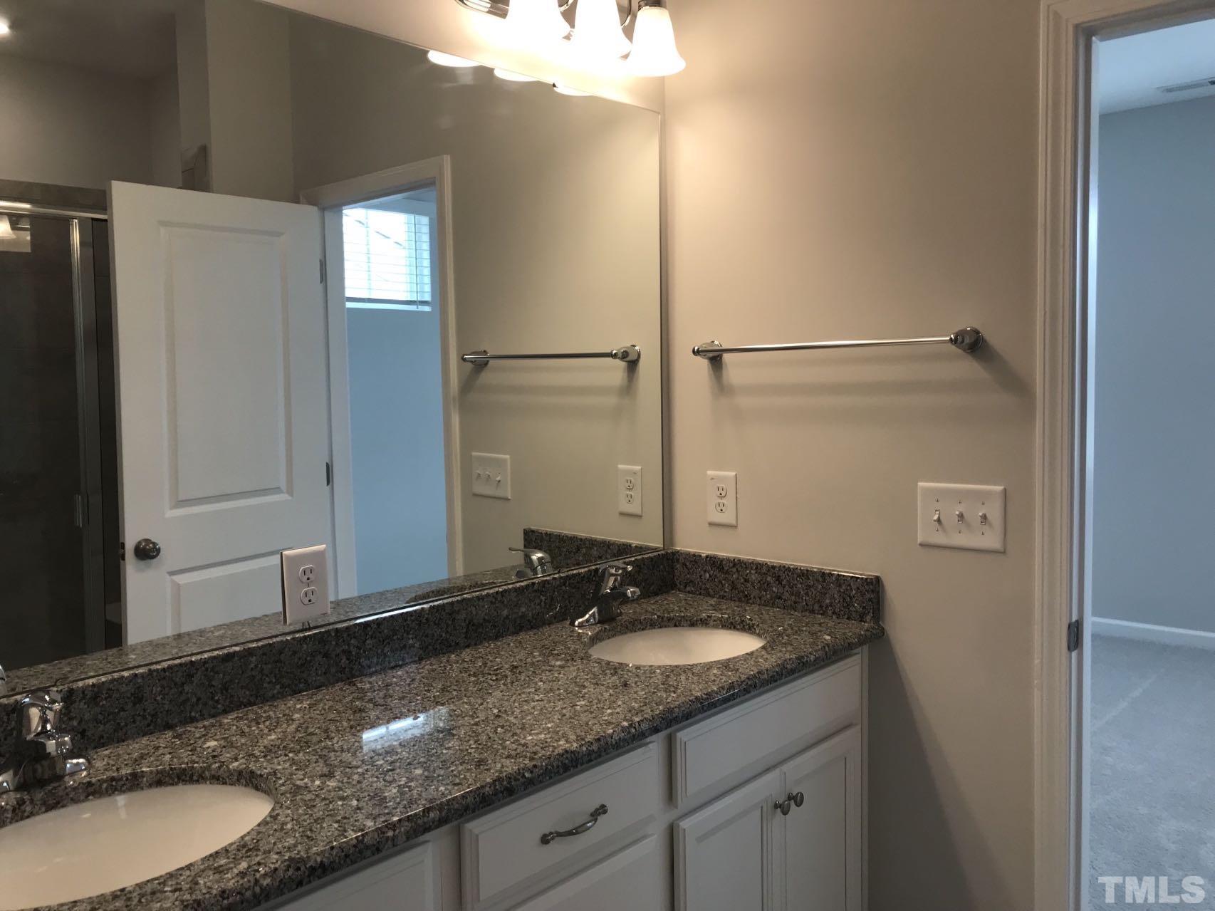 1258 Commack Drive Durham, NC 27703 - Photo 65 of 68 a bathroom with a granite countertop sink and a mirror