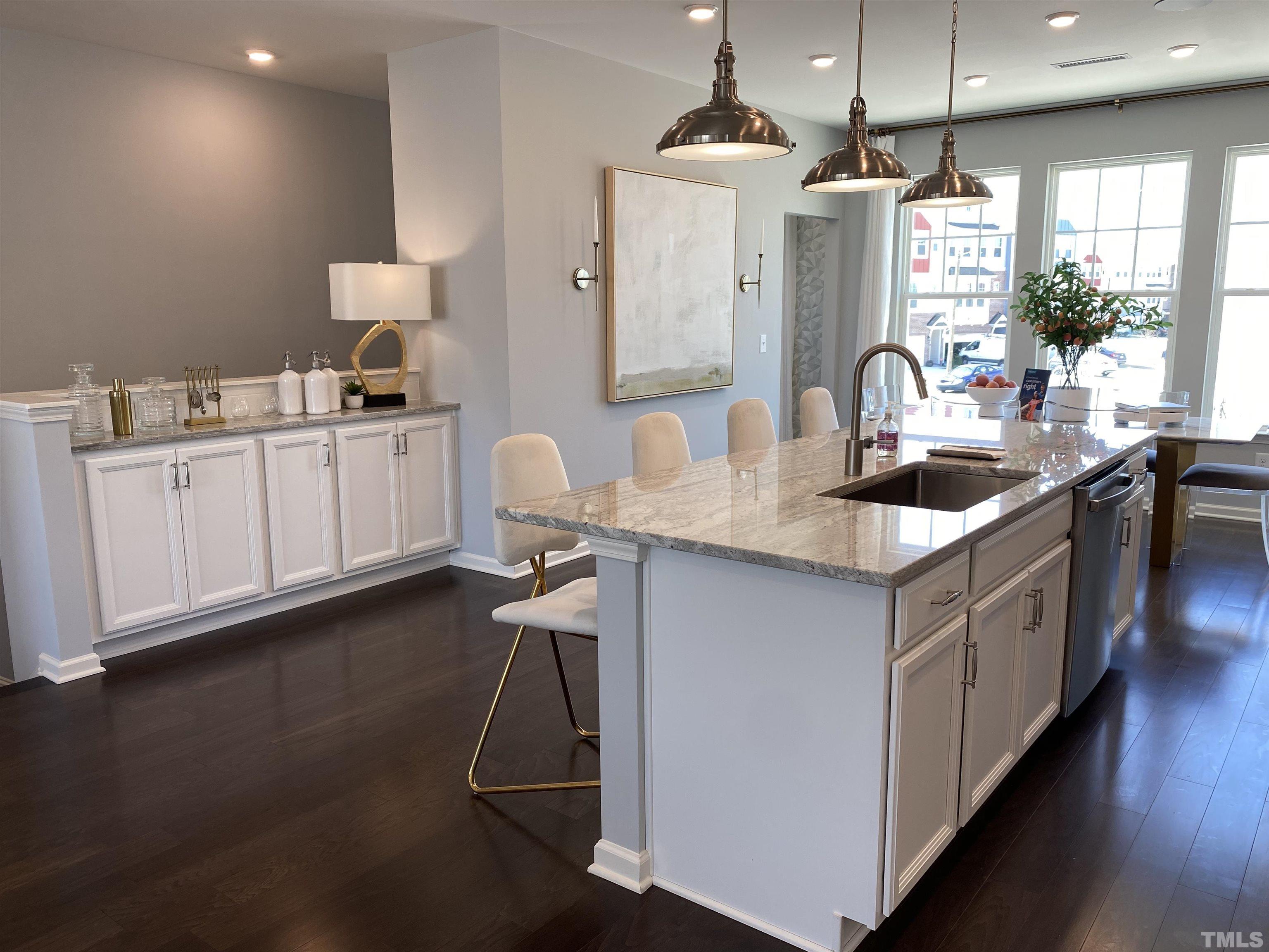 1258 Commack Drive Durham, NC 27703 - Photo 8 of 68 a kitchen with kitchen island granite countertop a sink a counter space appliances and cabinets
