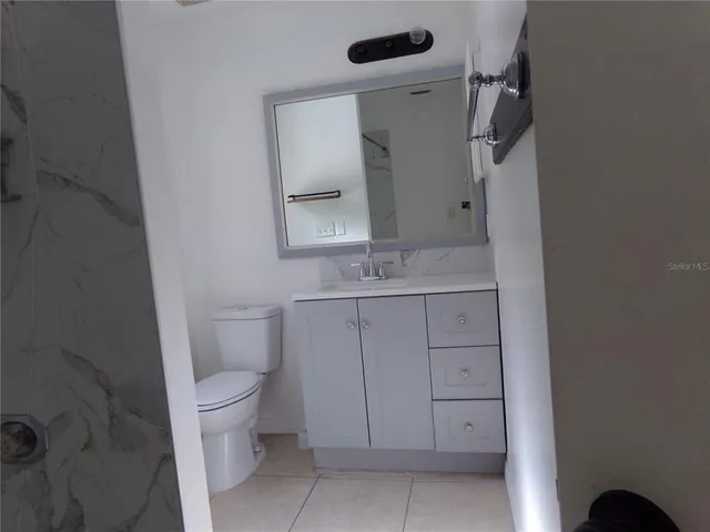a bathroom with a sink toilet and vanity