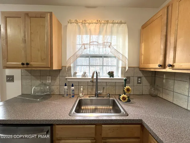 a kitchen with a sink and a white cabinets