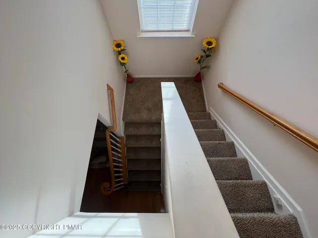 a room with furniture a window and a flat screen tv