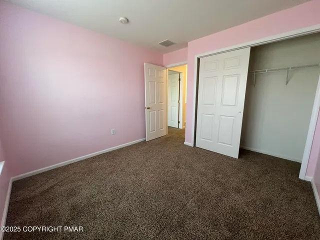 a view of a house with backyard and trees
