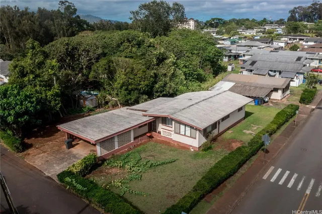 an aerial view of a house with yard and outdoor seating