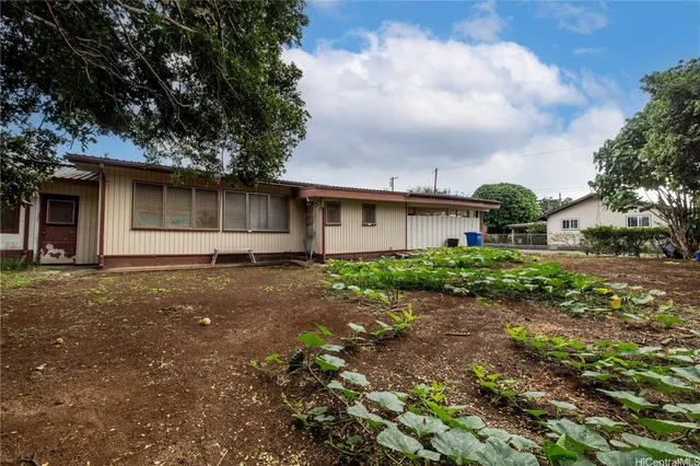 a backyard of a house with barbeque oven and table top
