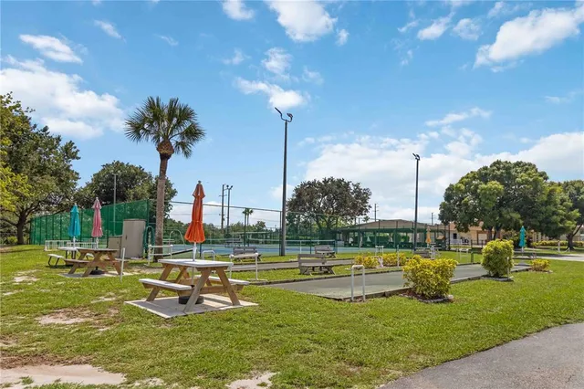 a view of a fountain in front of a house with a big yard