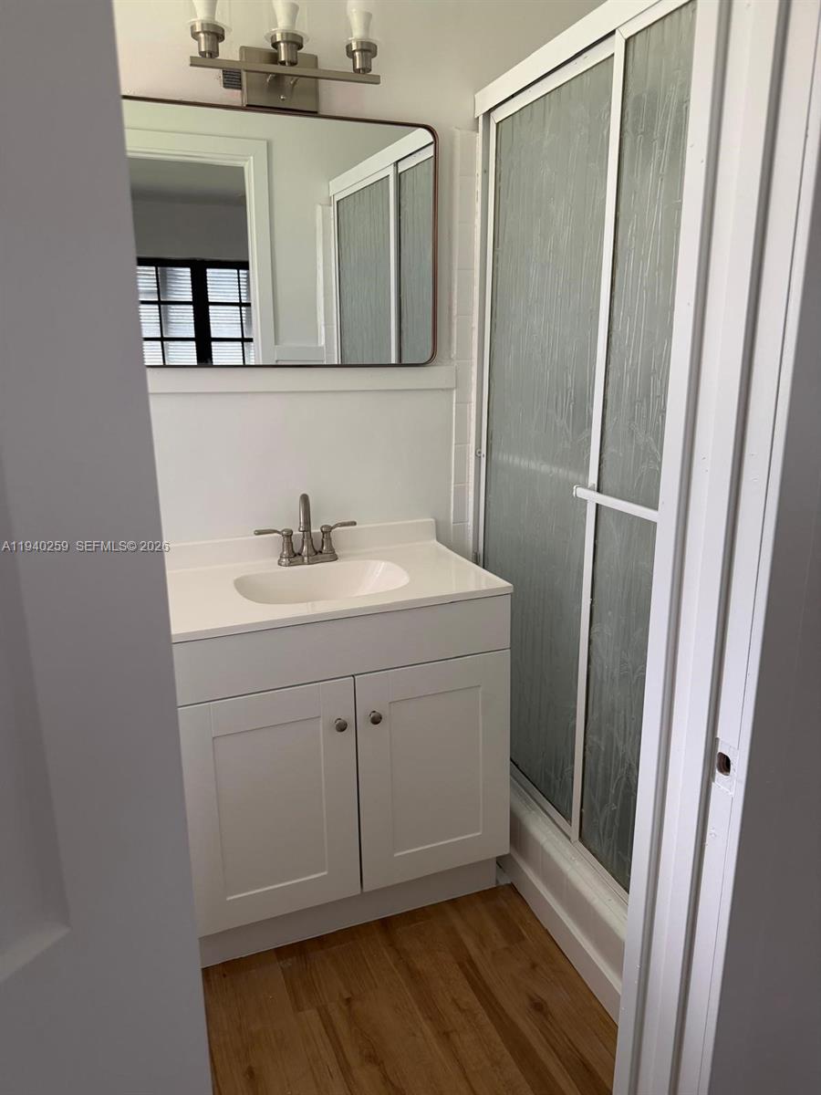 238 Southeast 3rd Street Dania Beach, FL 33004 - Photo 11 of 15 a bathroom with a sink and a mirror