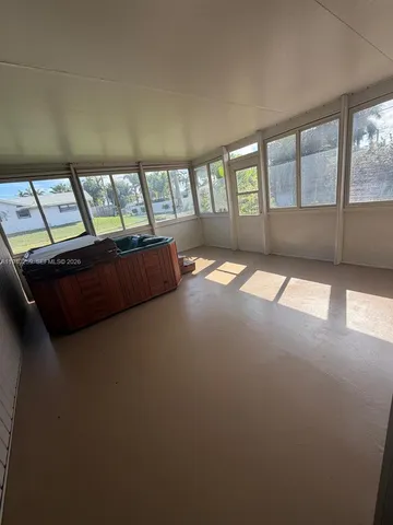 a living room with furniture and floor to ceiling window