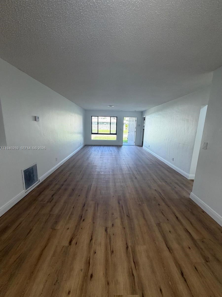 238 Southeast 3rd Street Dania Beach, FL 33004 - Photo 5 of 15 wooden floor in an empty room with a window