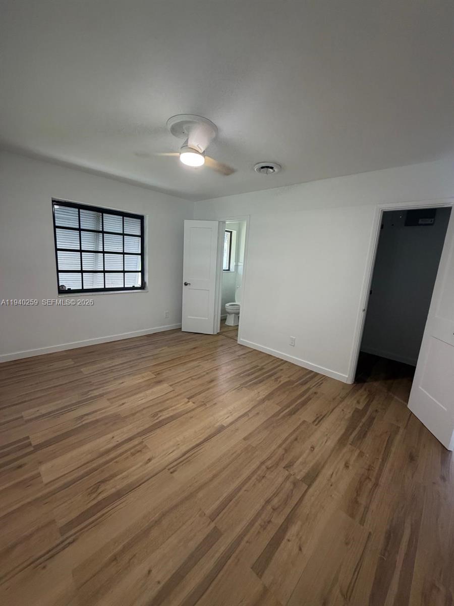 238 Southeast 3rd Street Dania Beach, FL 33004 - Photo 9 of 15 an empty room with wooden floor and windows