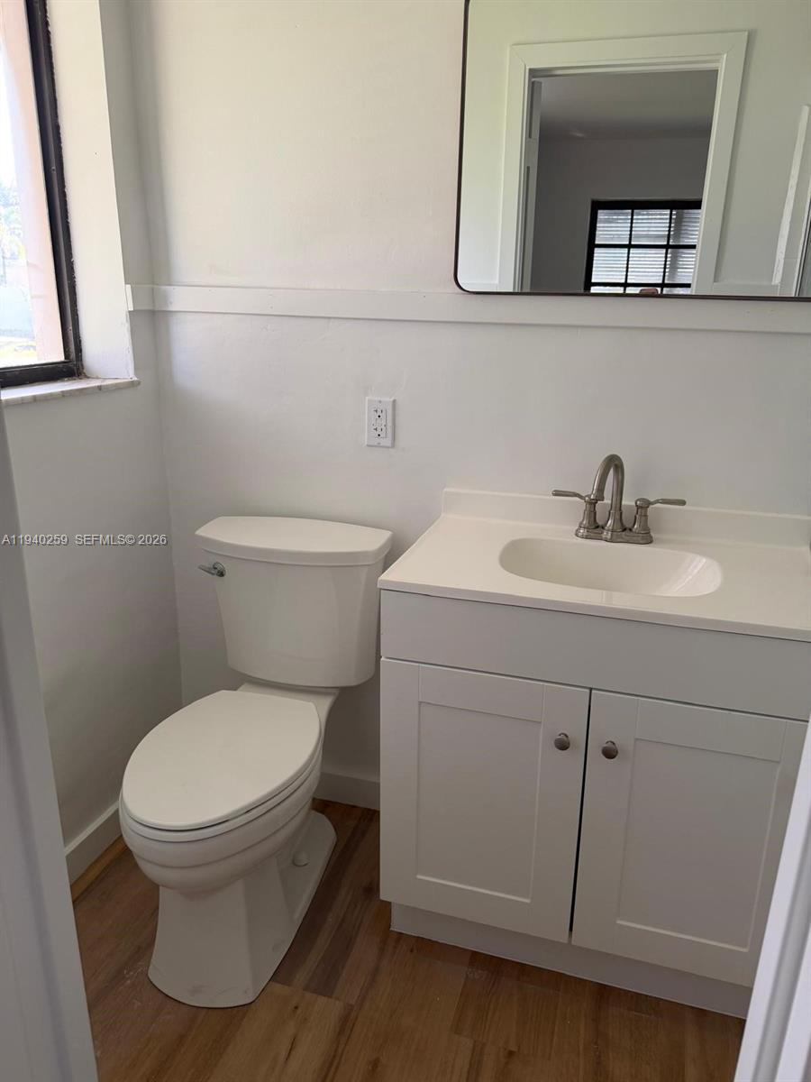 238 Southeast 3rd Street Dania Beach, FL 33004 - Photo 10 of 15 a bathroom with a toilet sink and mirror