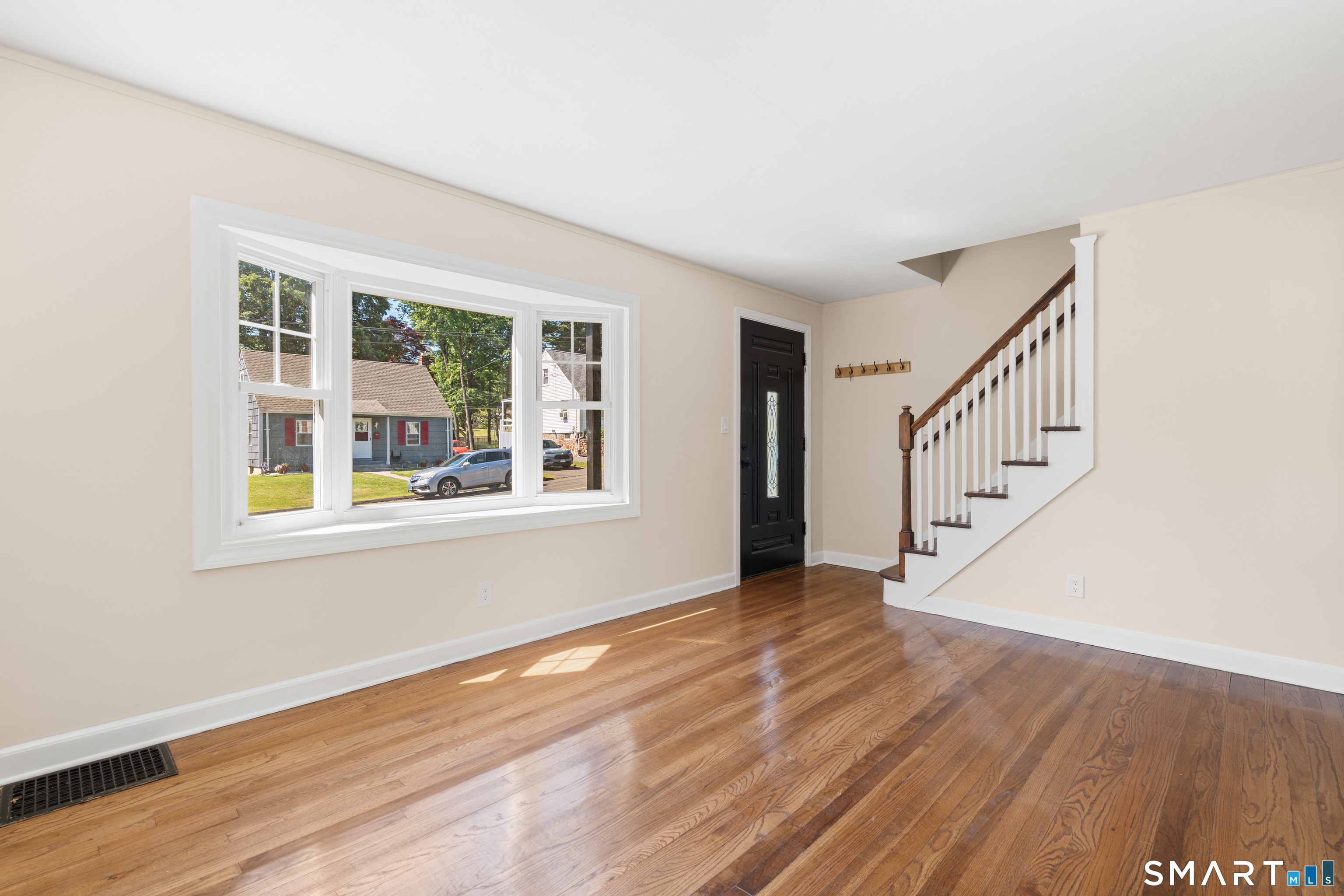 175 Moody Street Bristol, CT 06010 - Photo 10 of 28 a view of an empty room with wooden floor and a window
