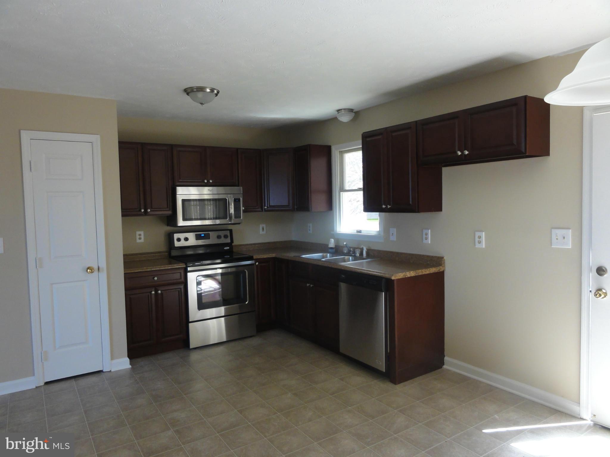 422 Long View Road Linden, VA 22642 - Photo 9 of 22 a kitchen with stainless steel appliances granite countertop a refrigerator and a stove top oven