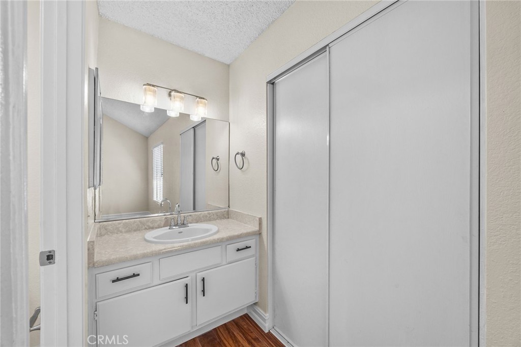 174 West Walnut Avenue, Unit B Rialto, CA 92376 - Photo 18 of 25 a bathroom with a granite countertop sink a mirror and a shower