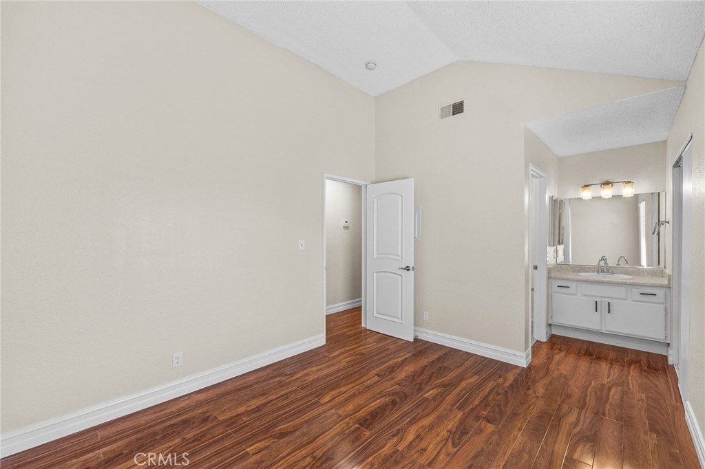 174 West Walnut Avenue, Unit B Rialto, CA 92376 - Photo 19 of 25 a view of an empty room with window and wooden floor