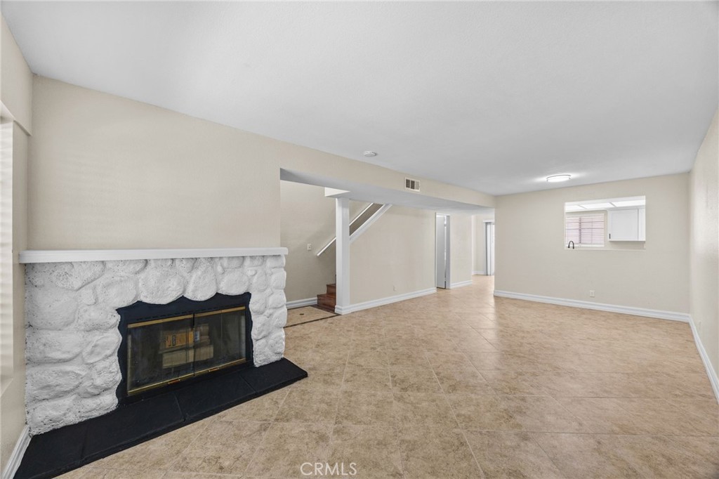 174 West Walnut Avenue, Unit B Rialto, CA 92376 - Photo 4 of 25 an empty room with fireplace and a fireplace