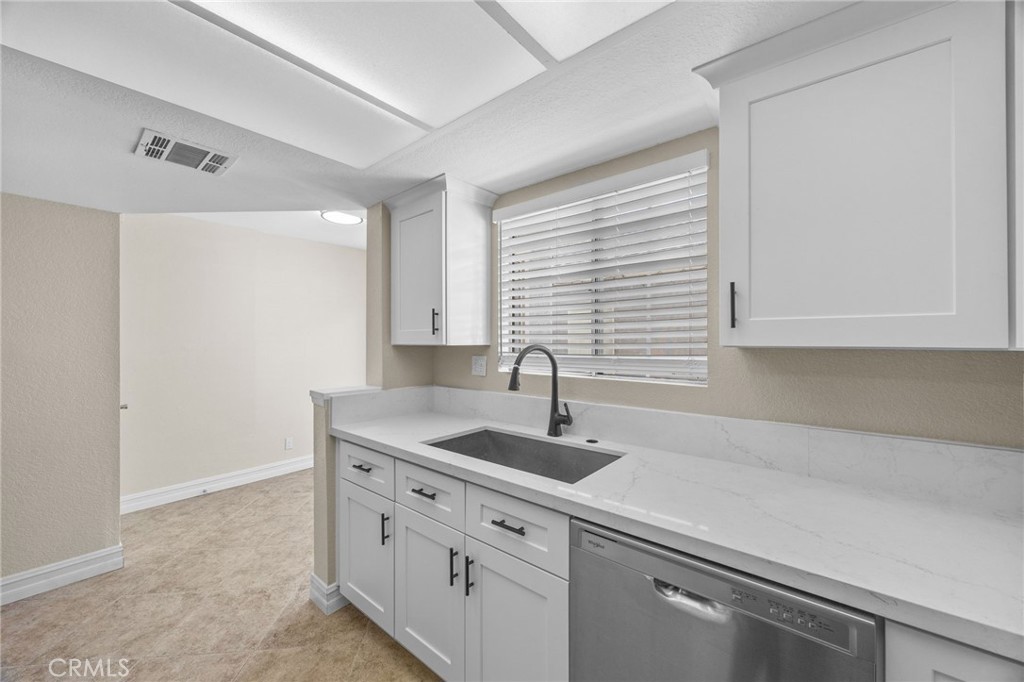 174 West Walnut Avenue, Unit B Rialto, CA 92376 - Photo 9 of 25 a kitchen with granite countertop white cabinets and a sink