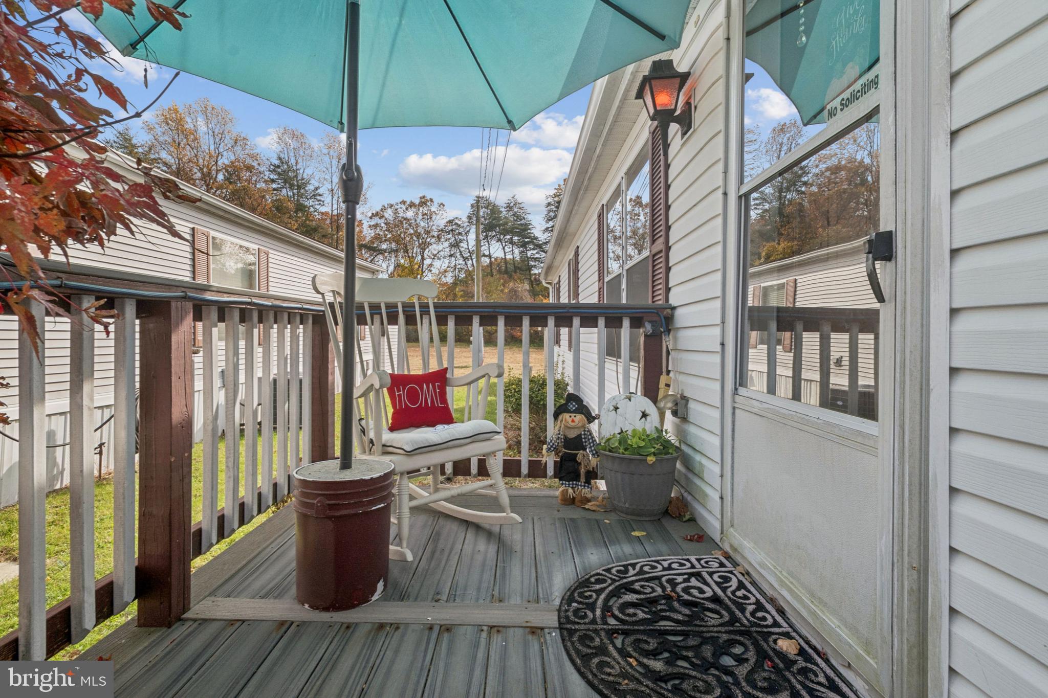 a view of balcony with wooden floor and seating space