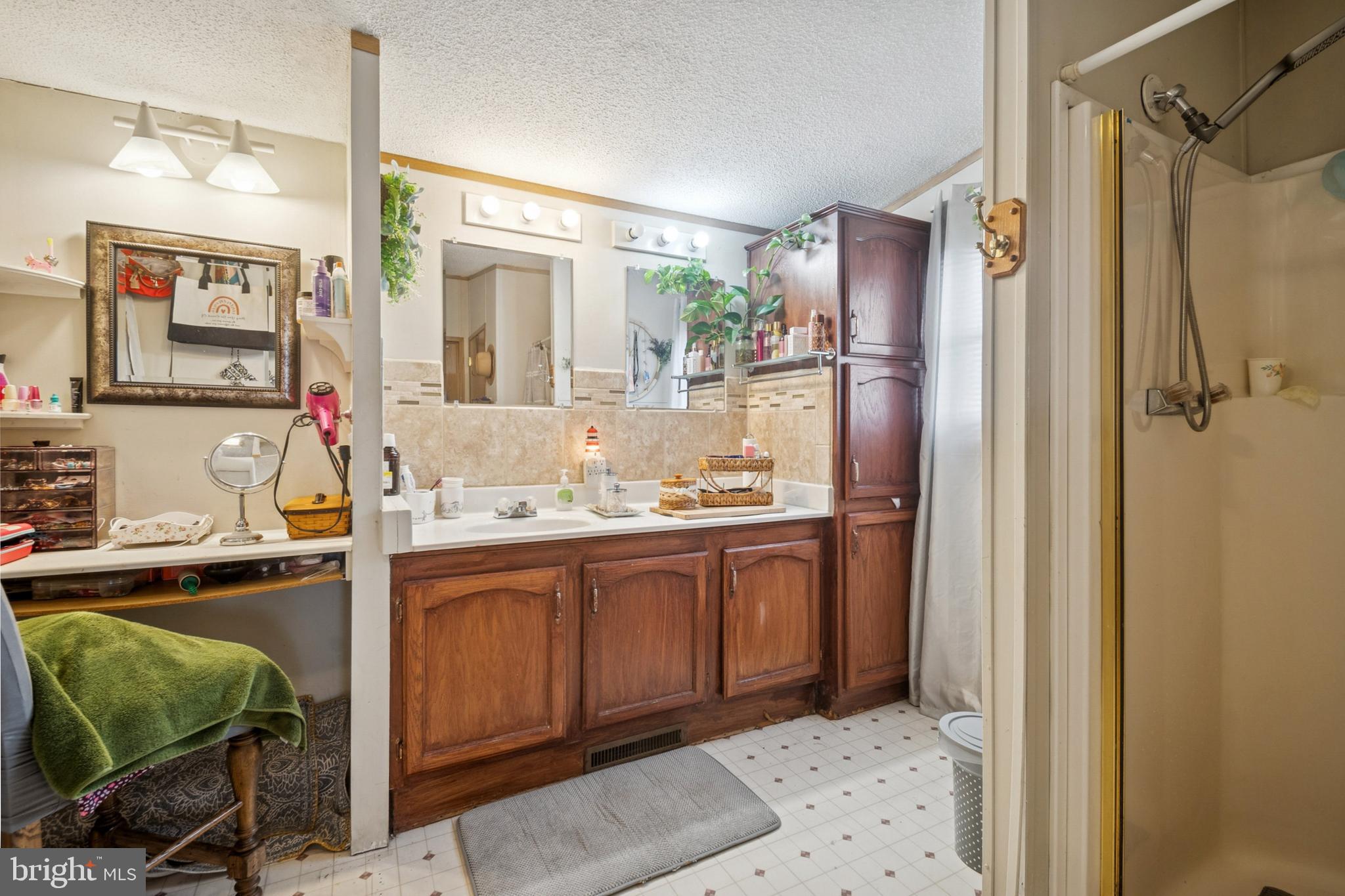 7959 Telegraph Road, Unit 5 Severn, MD 21144 - Photo 8 of 14 a bathroom with a sink mirror and a shower