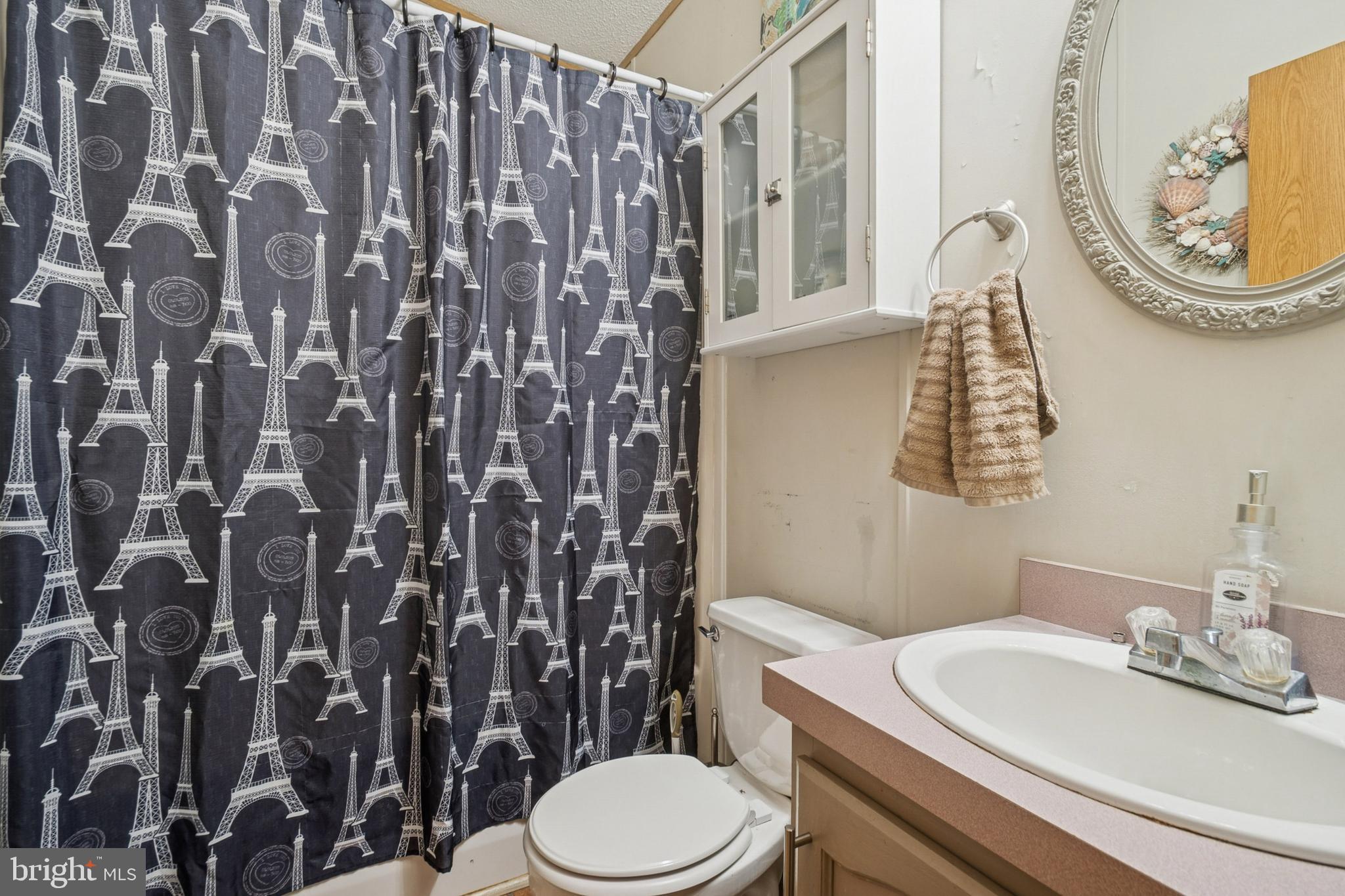 7959 Telegraph Road, Unit 5 Severn, MD 21144 - Photo 10 of 14 a bathroom with a granite countertop toilet and a sink