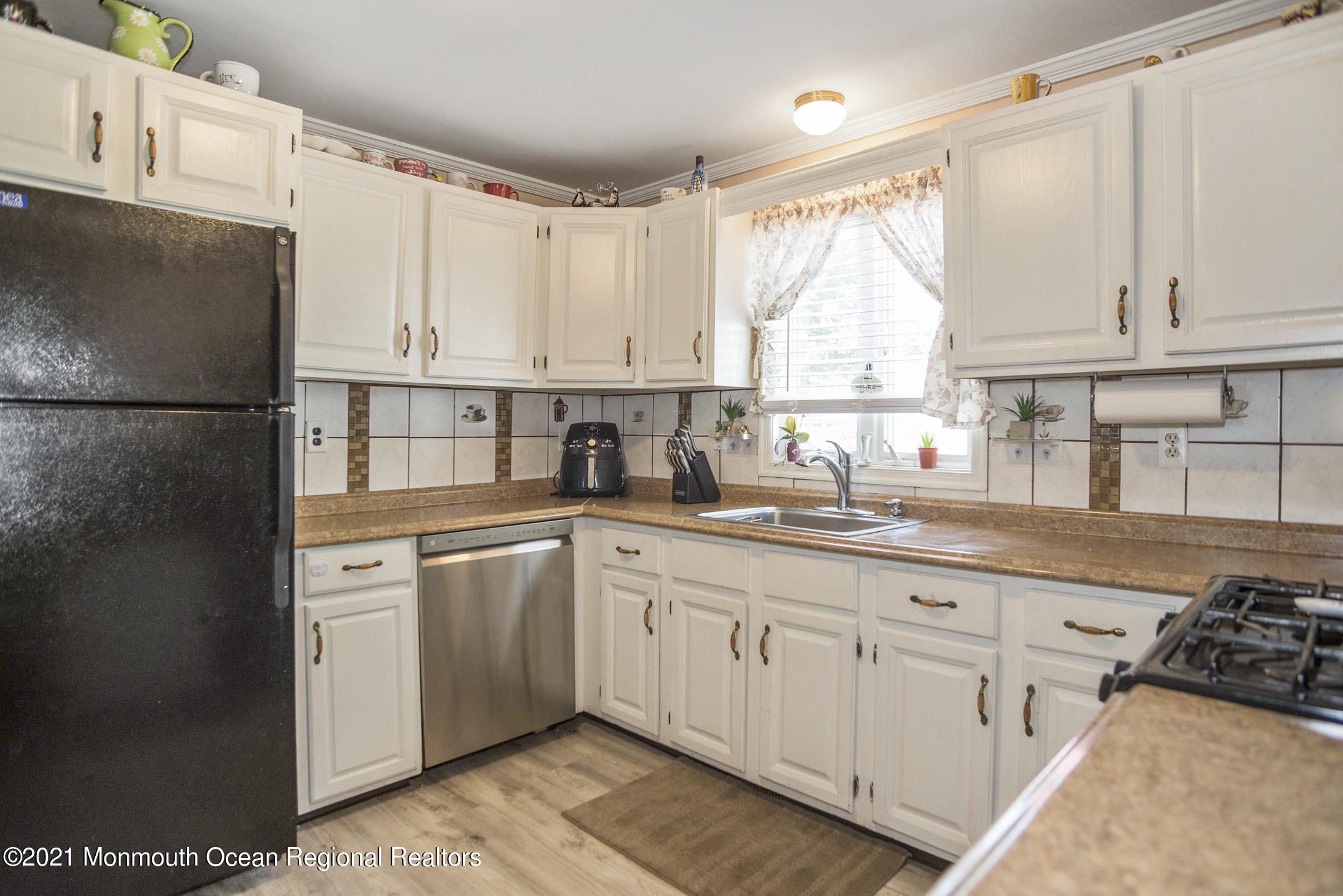 9 Pine Road Howell, NJ 07731 - Photo 15 of 26 a kitchen with granite countertop white cabinets white appliances a sink and a window