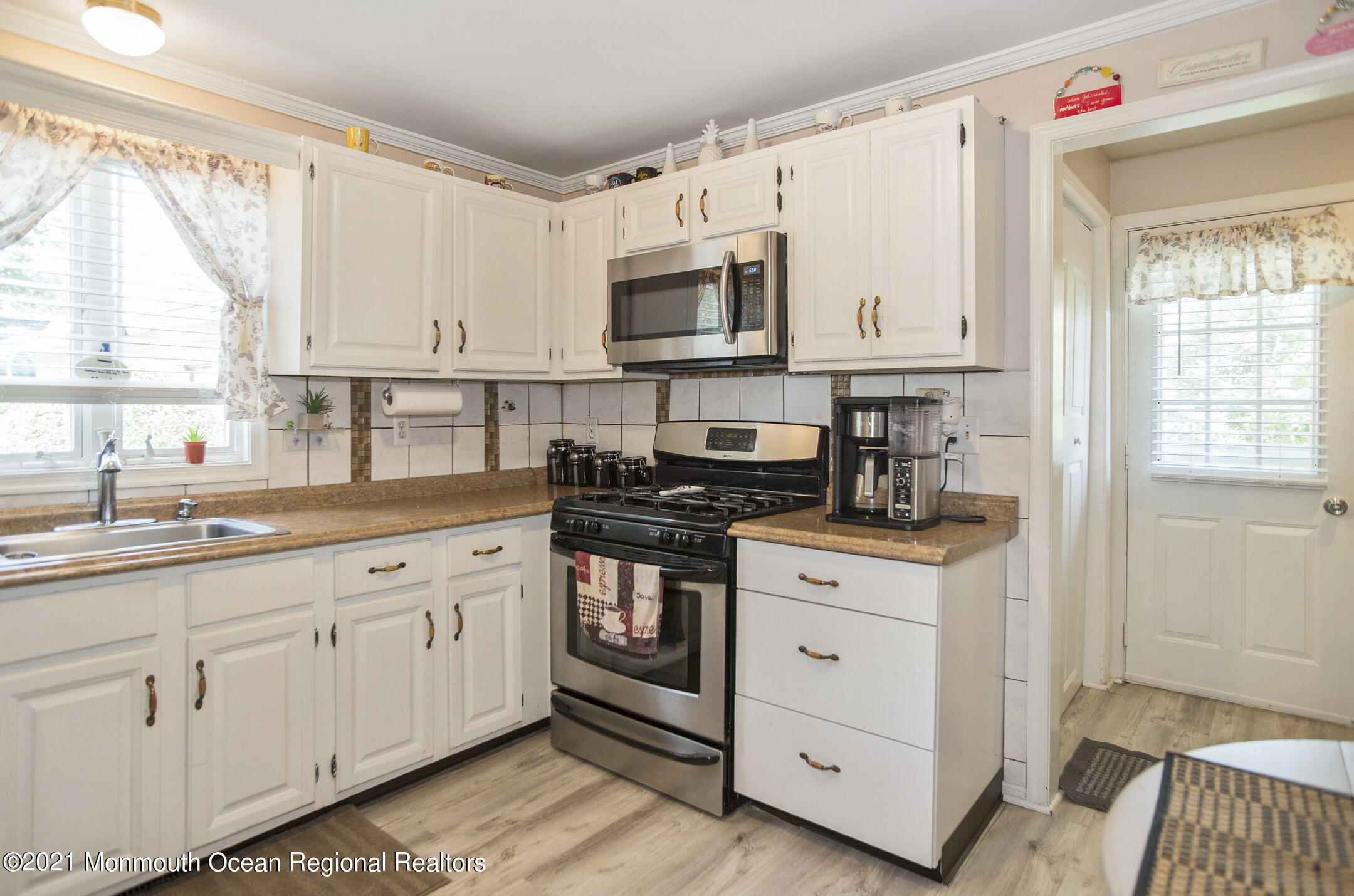 9 Pine Road Howell, NJ 07731 - Photo 16 of 26 a kitchen with granite countertop white cabinets and white appliances