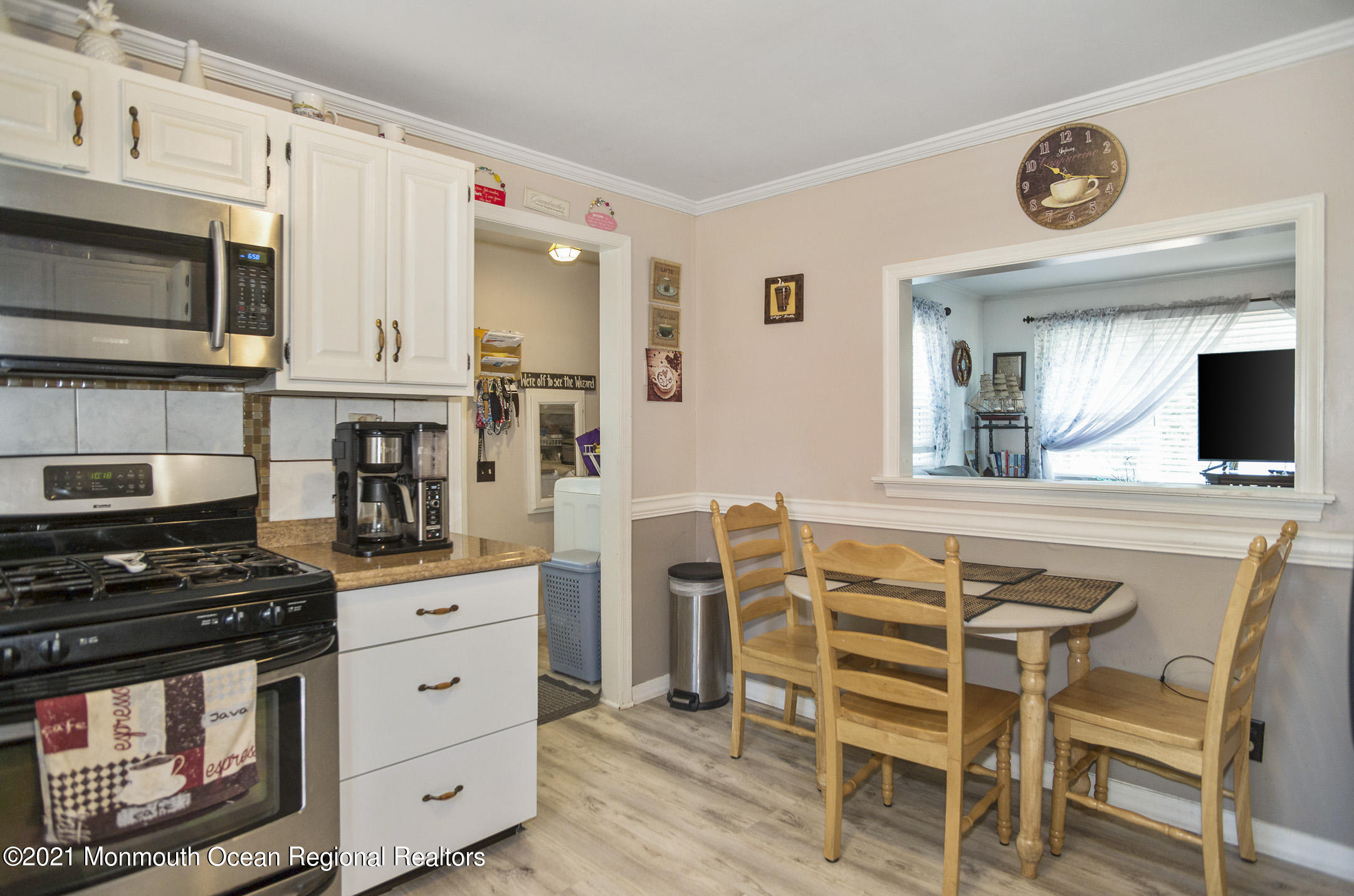9 Pine Road Howell, NJ 07731 - Photo 17 of 26 a kitchen with stainless steel appliances a stove a sink cabinets and a dining table