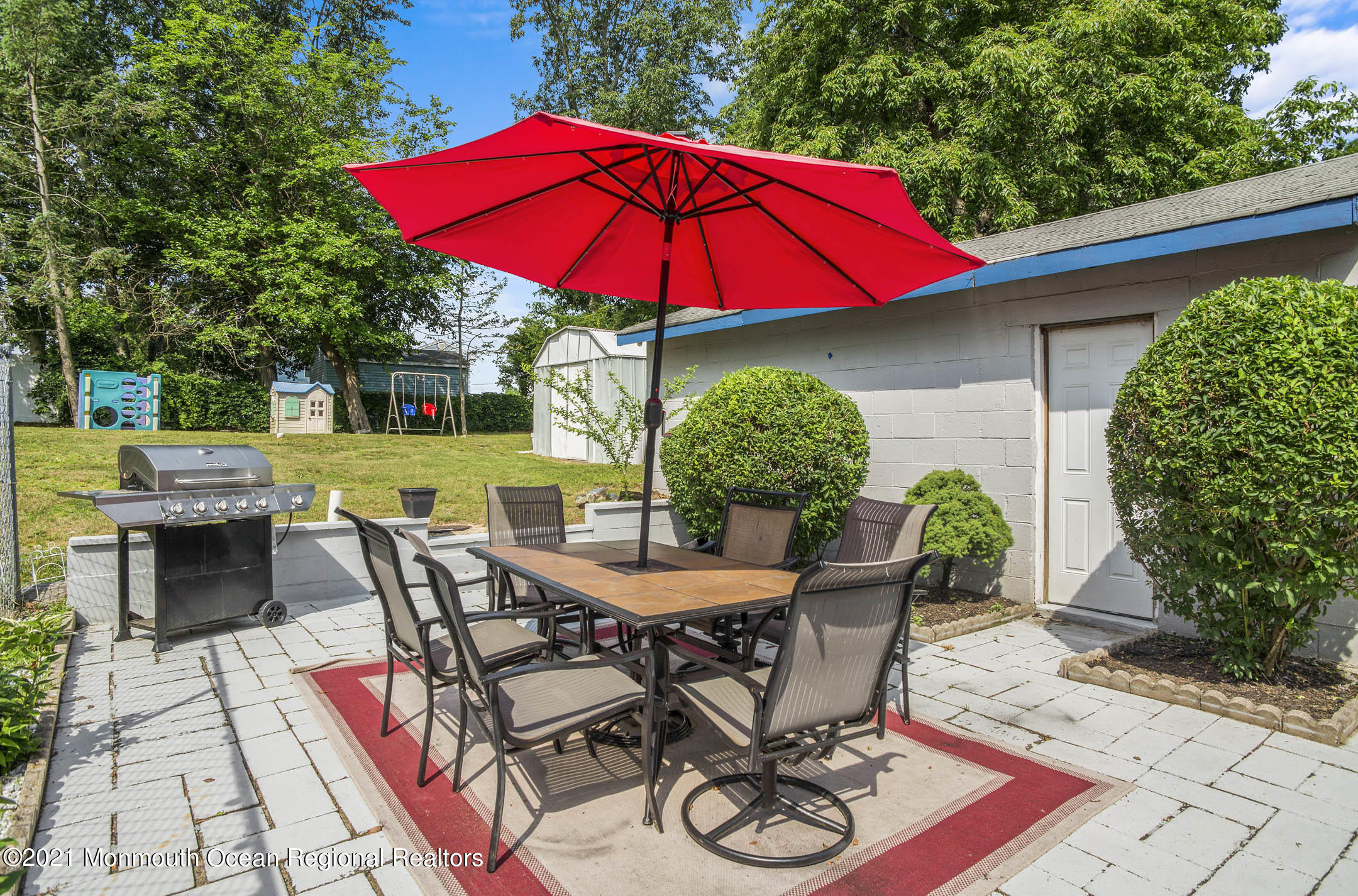 9 Pine Road Howell, NJ 07731 - Photo 23 of 26 a view of a patio with table and chairs under an umbrella