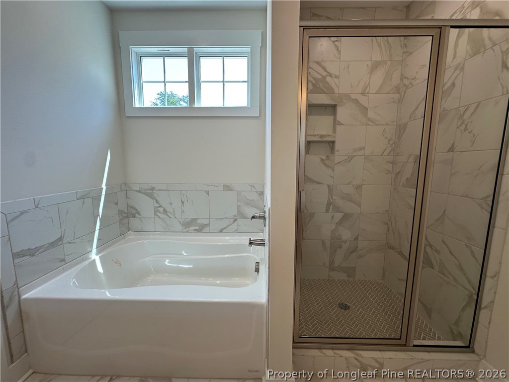 2908 Calloway Road Raeford, NC 28376 - Photo 17 of 25 a bathroom with a bathtub