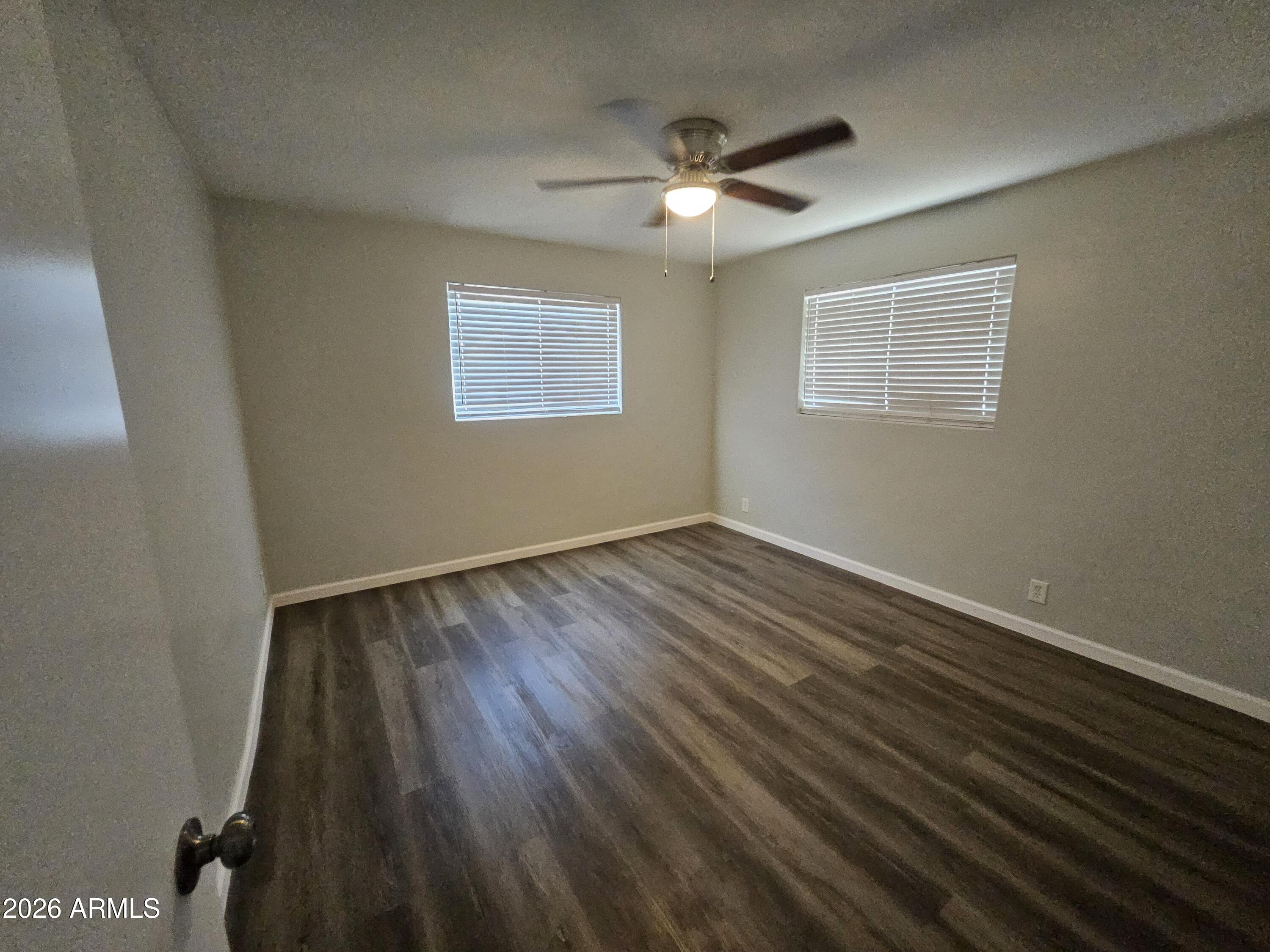 524 West 3rd Place Mesa, AZ 85201 - Photo 14 of 23 a view of an empty room with wooden floor and a window